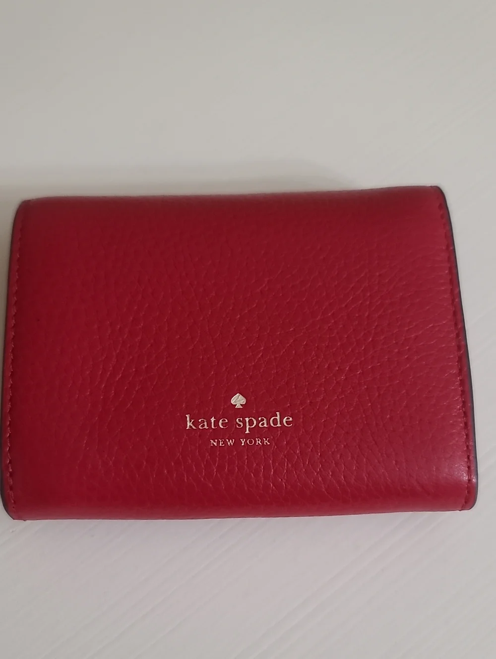 kate spade red pebbled leather trifold wallet with gold spade logo